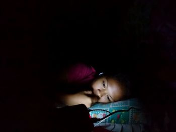 Young woman in dark room