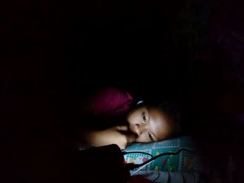 Young woman in dark room