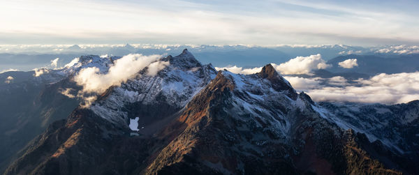 Panoramic view of snowcapped mountains against sky