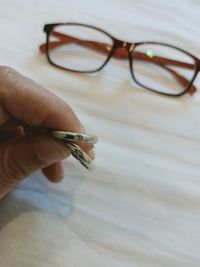 Close-up of hand holding eyeglasses