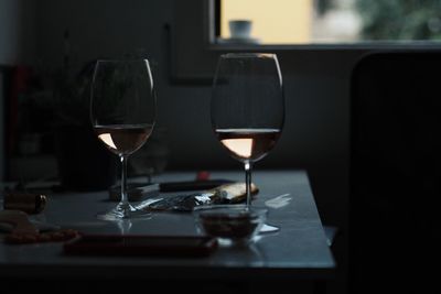 Close-up of wine glasses on table