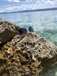 View of rock on beach against sky