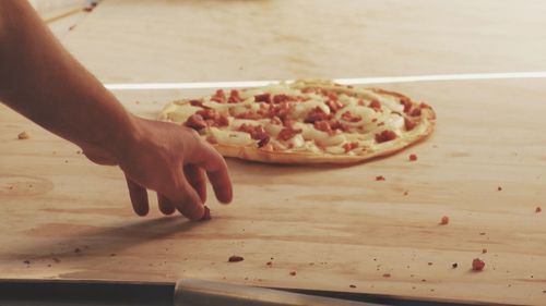Close-up of hand holding food on table