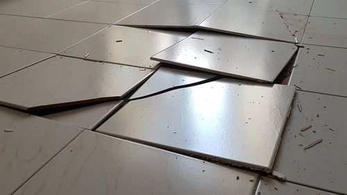 Low angle view of broken glass on floor
