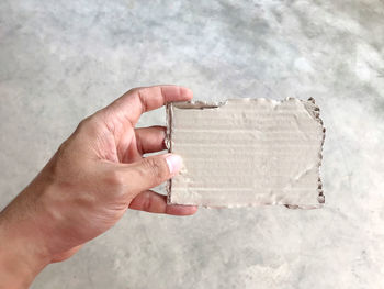 High angle view of person hand holding paper