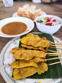 Fried meat and sauce on table