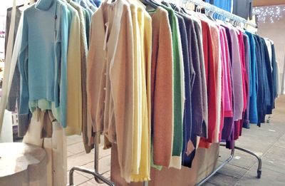Close-up of multi colored clothes hanging at store