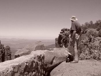 Full length of man standing on rock at cederberg against clear sky