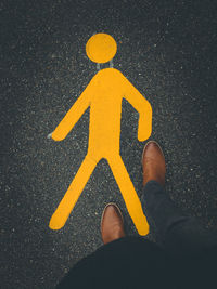 Low section of person standing on road