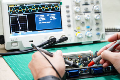 Midsection of man working on table