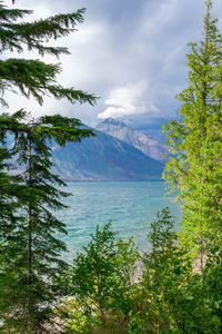 Scenic view of sea and mountains against sky