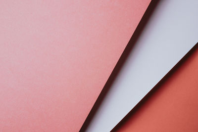 High angle view of paper on pink background