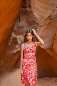 Portrait of young woman standing in cave