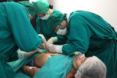 Doctors doing surgery on patient in hospital