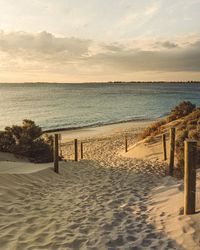 Scenic view of beach against sky during sunset