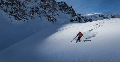 Man skiing on snowcapped mountain