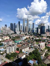 High angle view of modern buildings in city against sky