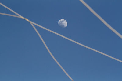 Low angle view of vapor trail in blue sky