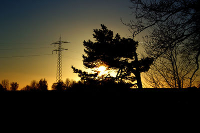 Silhouette trees against sky during sunset