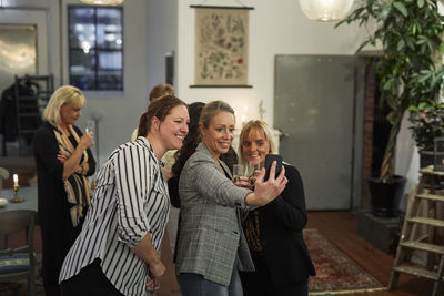 Group of women taking selfie at meeting in cafe