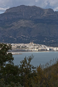 Scenic view of sea and mountains against sky