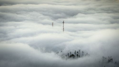 Silhouette of people against cloudy sky
