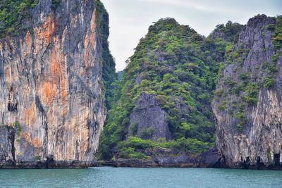 Scenic view of rock formation by sea against sky