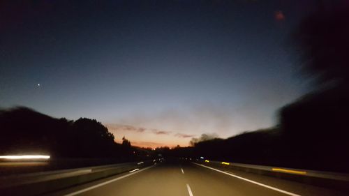 Highway against sky at night