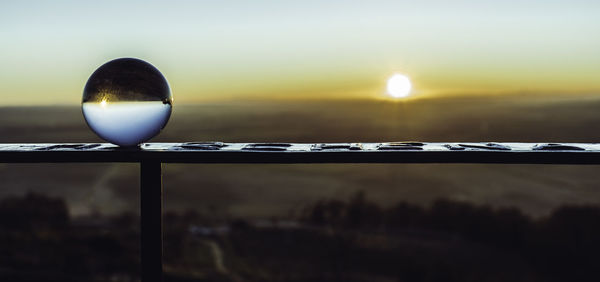 Close-up of water against sky during sunset