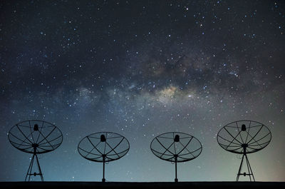 Low angle view of satellites against star field at night