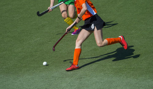 Low section of people playing soccer ball