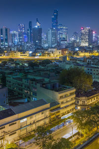 High angle view of illuminated buildings in city at night