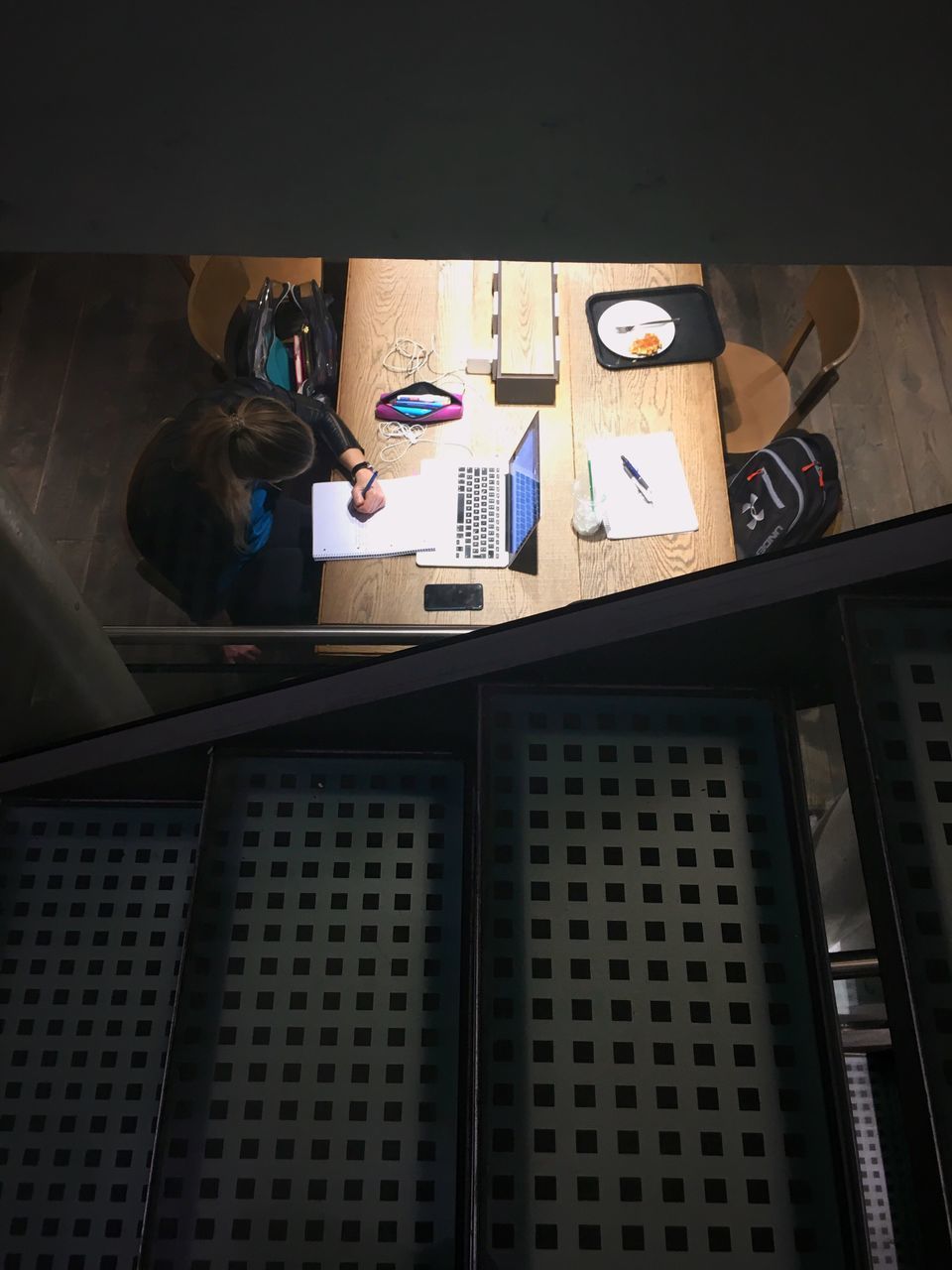 HIGH ANGLE VIEW OF PEOPLE SITTING ON TABLE AT BUILDING