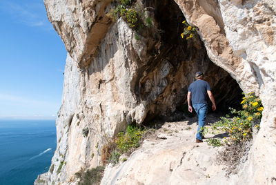 Man exploring one of the goats hair twin caves in gibraltar
