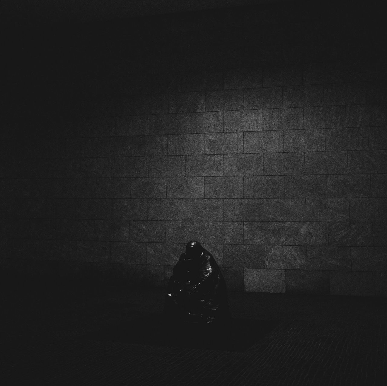 indoors, wall - building feature, copy space, dark, night, high angle view, still life, shadow, wall, no people, vignette, absence, single object, close-up, abandoned, textured, illuminated, light - natural phenomenon, street, table