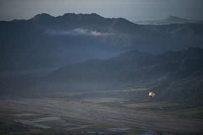 High angle view of land and mountains against sky