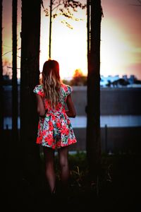 Woman standing at sunset