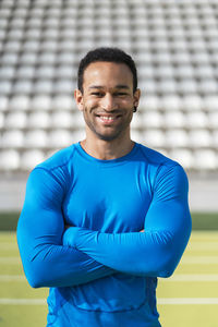 Portrait of smiling man standing in stadium