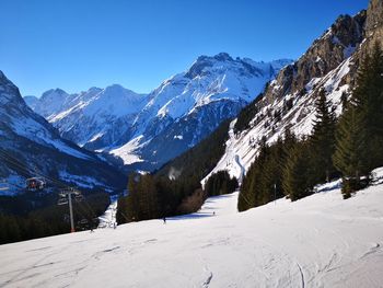 Scenic view of snow covered mountains against sky