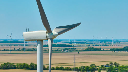 Close-up of windmill against sky