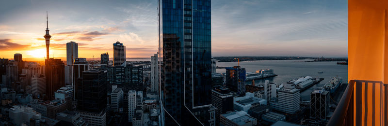 Auckland cityscape against sky during sunset panoramic