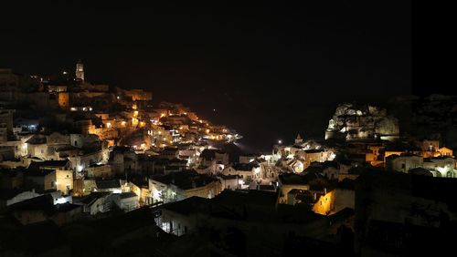 Illuminated city against sky at night