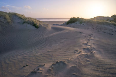 Scenic view of beach against sky during sunset