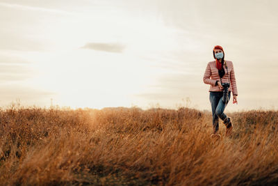 Full length of man standing on field against sky