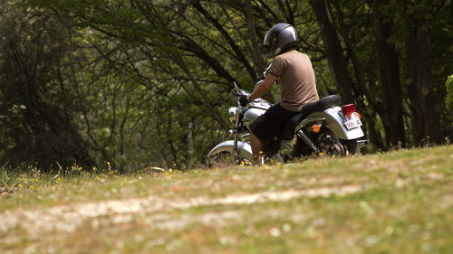 Man riding motorcycle on field