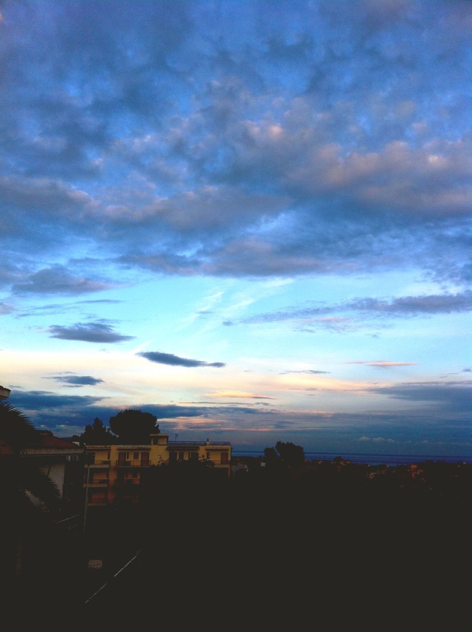 sky, building exterior, cloud - sky, architecture, built structure, sunset, silhouette, cloudy, cloud, dusk, house, scenics, beauty in nature, dramatic sky, nature, residential structure, weather, outdoors, city, residential building