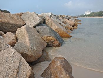 Rocks in sea against sky