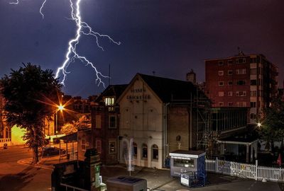 Illuminated buildings against sky at night