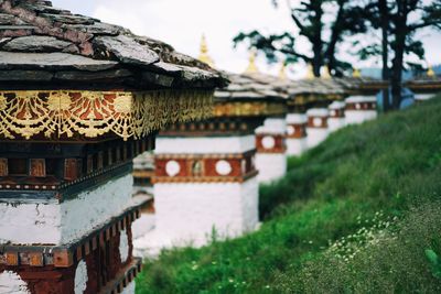 Row of stupas on grassy field