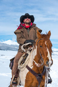 Man riding horse in snow